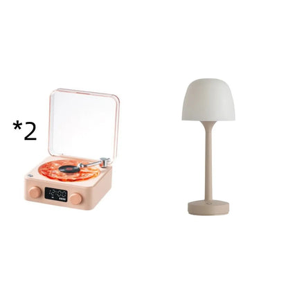 Retro-style turntable Bluetooth speaker with glowing RGB light projection on a wooden surface.