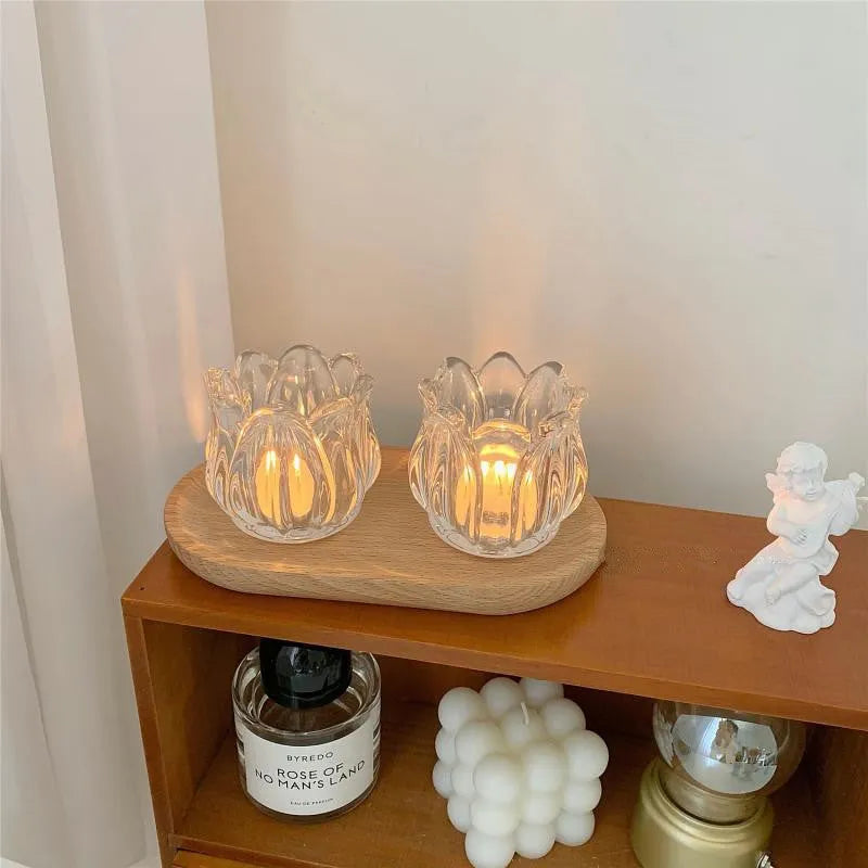 Transparent glass tulip candle holder with classic tumbler base on table