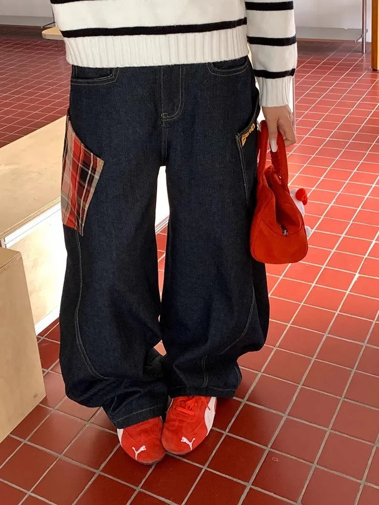 Loose straight-leg cotton trousers in a red plaid pattern, laid flat.