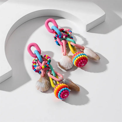 Handmade bohemian shell tassel earrings for women with colourful flower and geometric drop design
