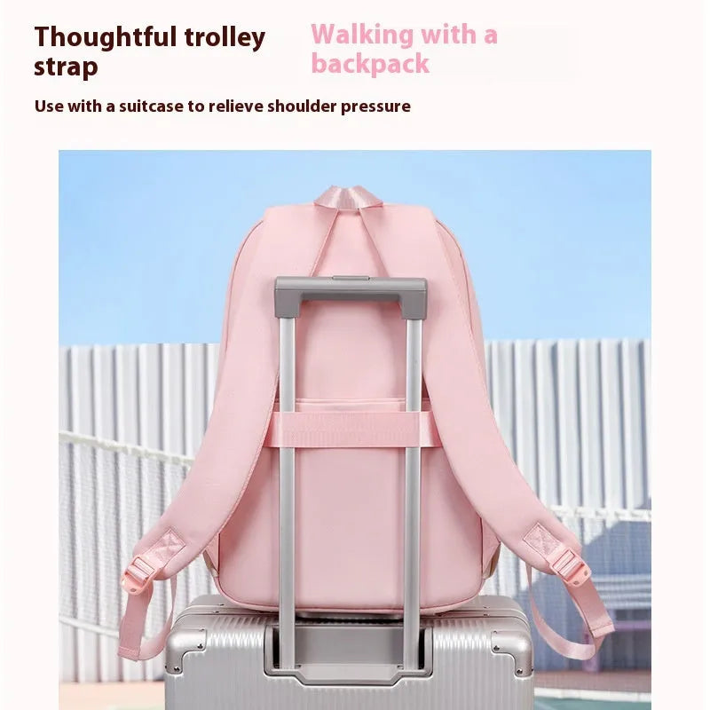 Pink girls school backpack with curved shoulder straps on a wooden floor