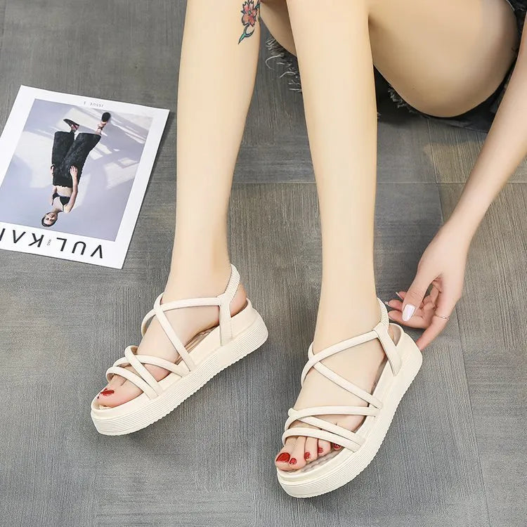Women's black Roman platform sandals with straps on a white background.