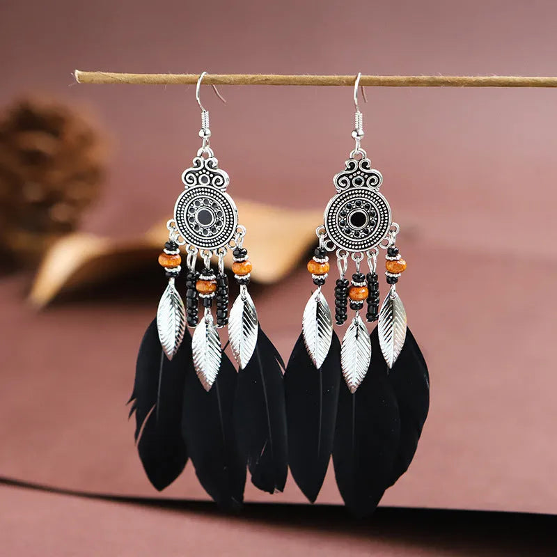 Round drop feather earrings in a bohemian leaf shape with patterned detail, shown in a light pink electroplated colour.