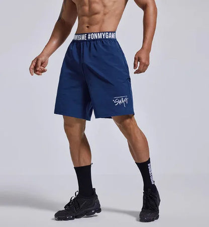 Men's loose black sports shorts with elastic waist and letter detail, shown front and back.