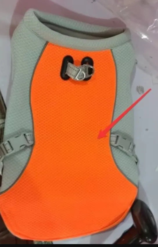 Orange polyester dog cooling vest with layered construction for evaporative cooling and UV protection.