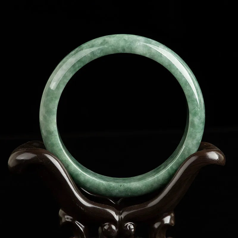 Natural deep pea green jade bracelet on wrist, simple style with certificate and gift box.