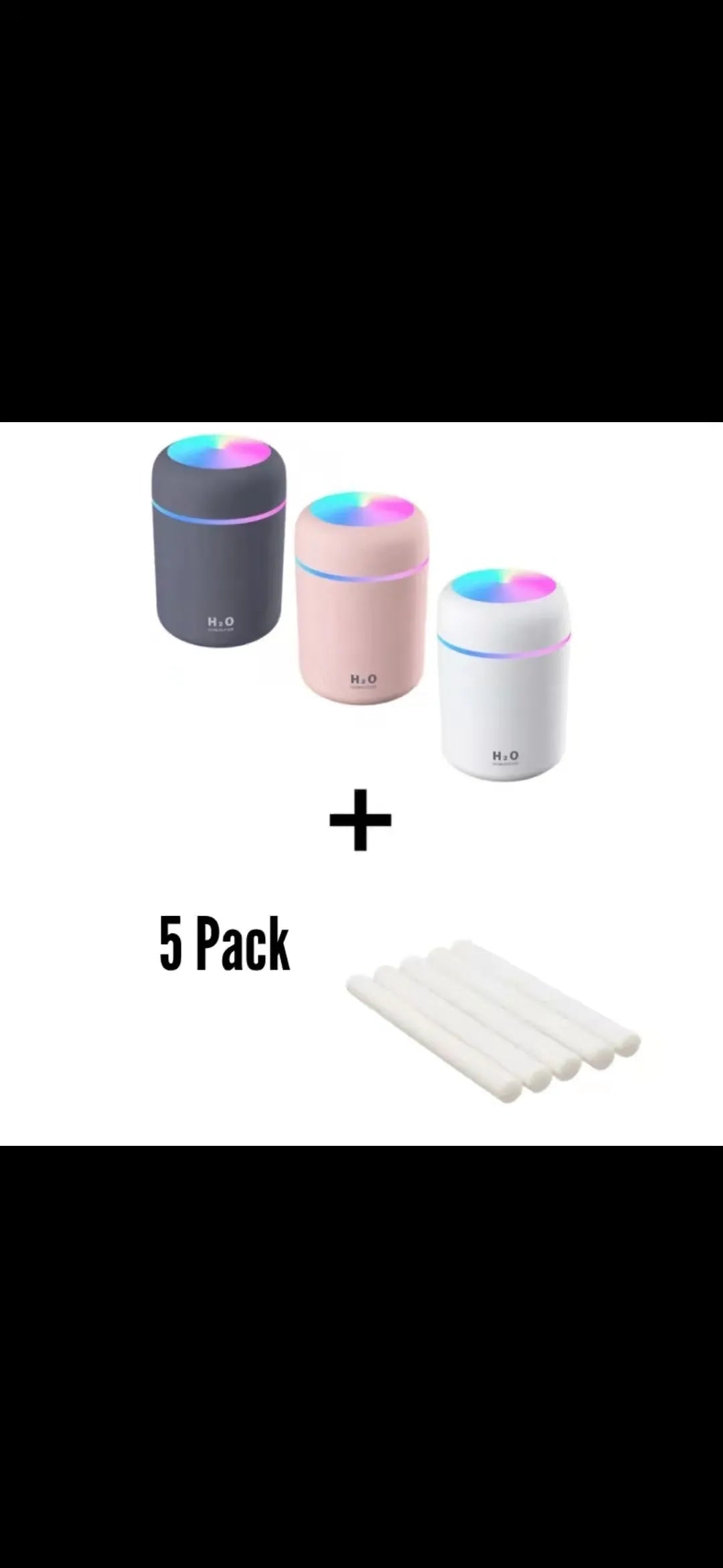 Pink USB desktop humidifier with LED lights and water tank on wooden desk