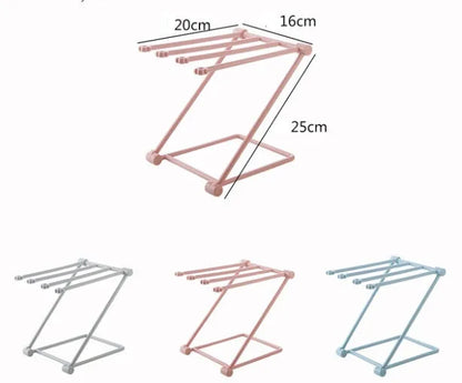 Foldable plastic dishcloth shelf organiser in light blue mounted on a wall.