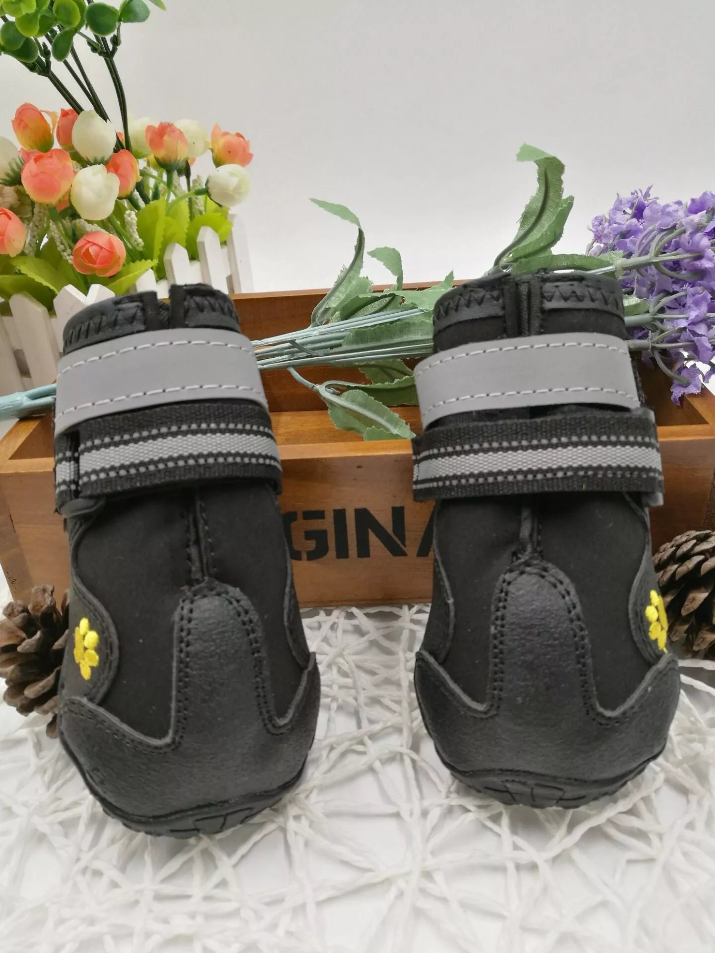 Black waterproof dog shoes with non-slip soles and adjustable fuzzy belt