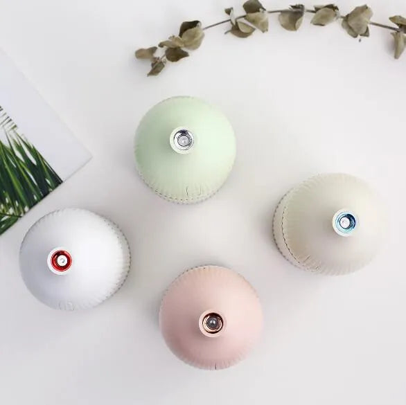 White ultrasonic aromatherapy diffuser and air humidifier with LED light, 300ml capacity, on a desk.