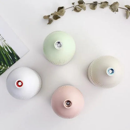 White ultrasonic aromatherapy diffuser and air humidifier with LED light, 300ml capacity, on a desk.