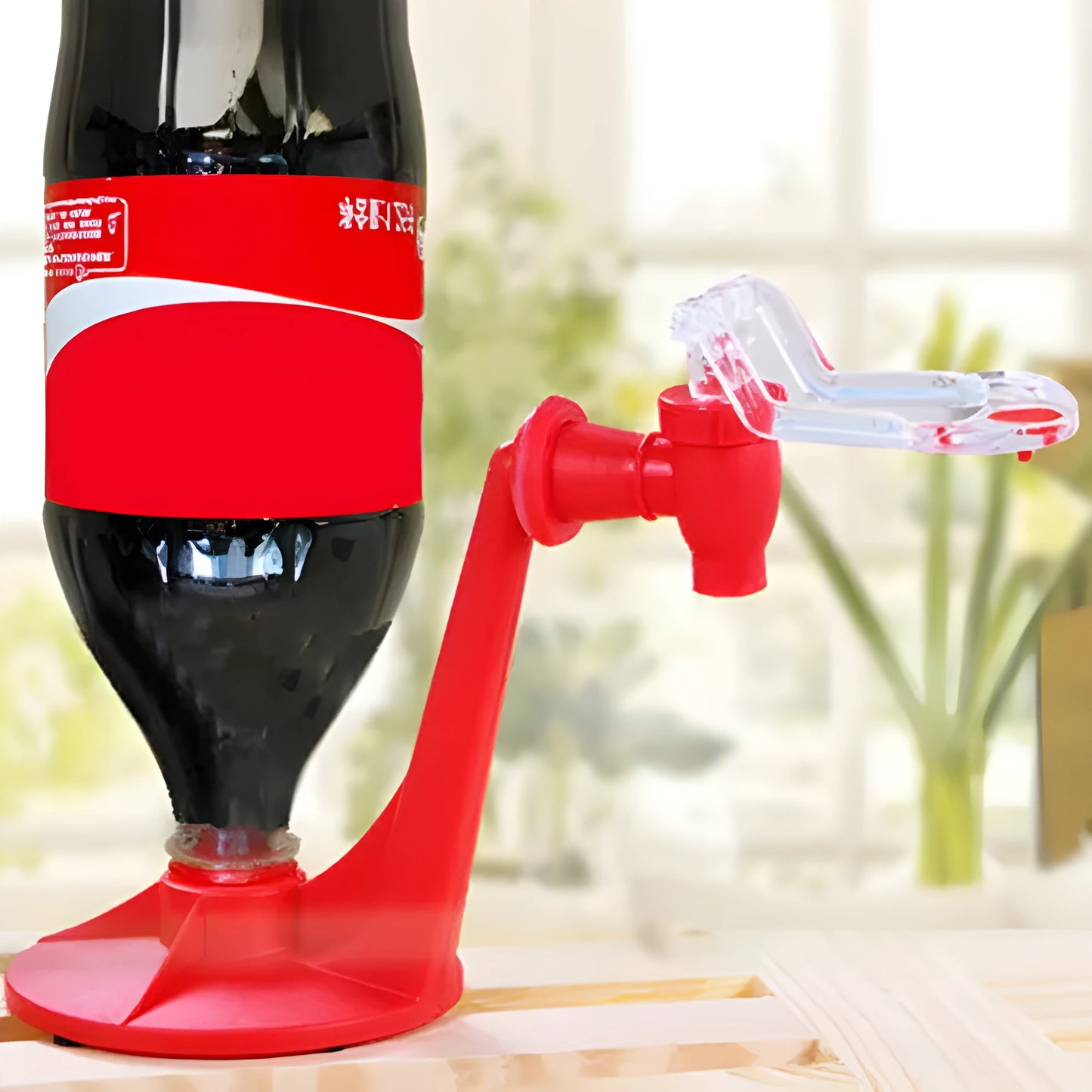 Red ABS plastic soft drink dispenser mounted on inverted beverage bottle