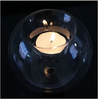 Handmade hollow round glass candle holder in European style on a table.