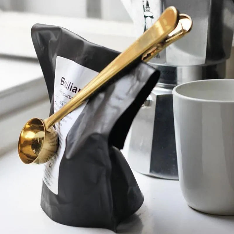 Silver stainless steel coffee scoop with integrated bag clip, measuring 17.5cm long