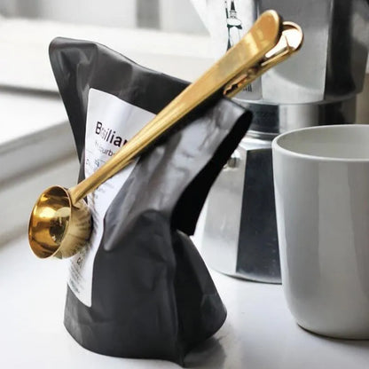 Silver stainless steel coffee scoop with integrated bag clip, measuring 17.5cm long
