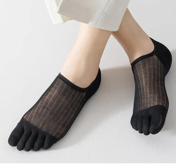 Pair of solid colour modal five-finger socks laid flat, showing toe separation and thin fabric texture.