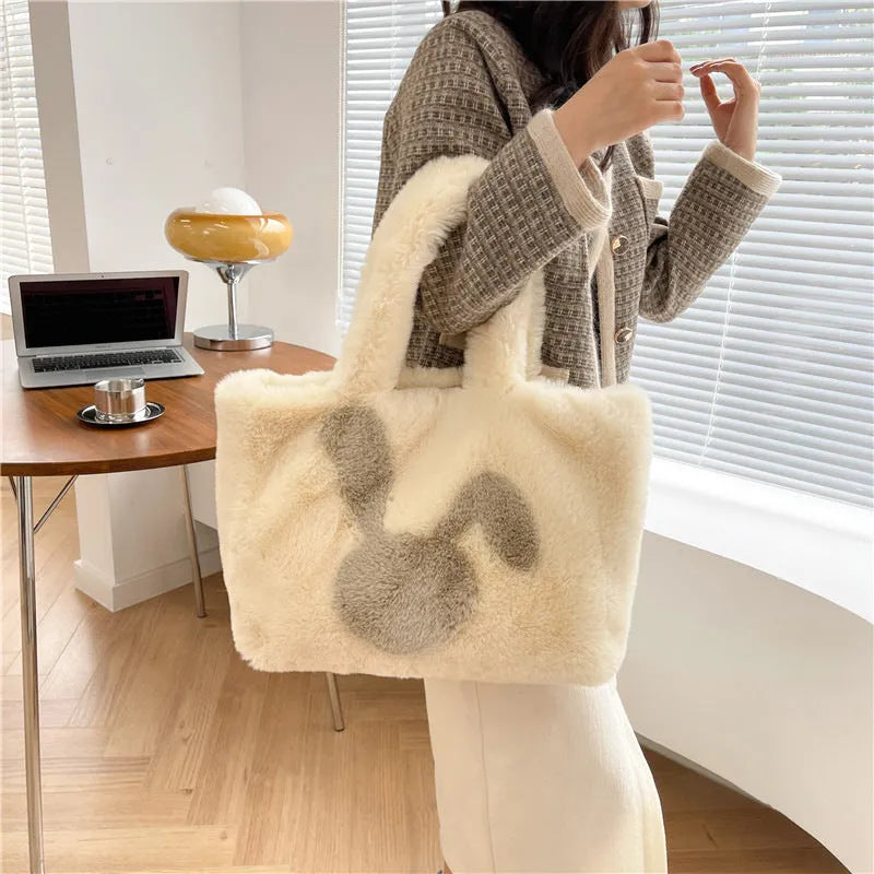 Soft plush tote bag with cartoon rabbit ears in solid colours like beige, pink, and black.