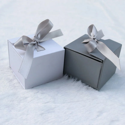Grey square jewellery box with white ribbon bow measuring 5x5x4cm with sponge-lined interior