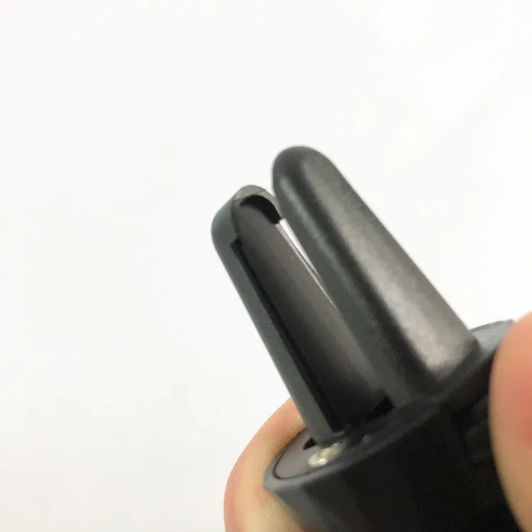 Matte black car phone holder clipped onto a car air vent