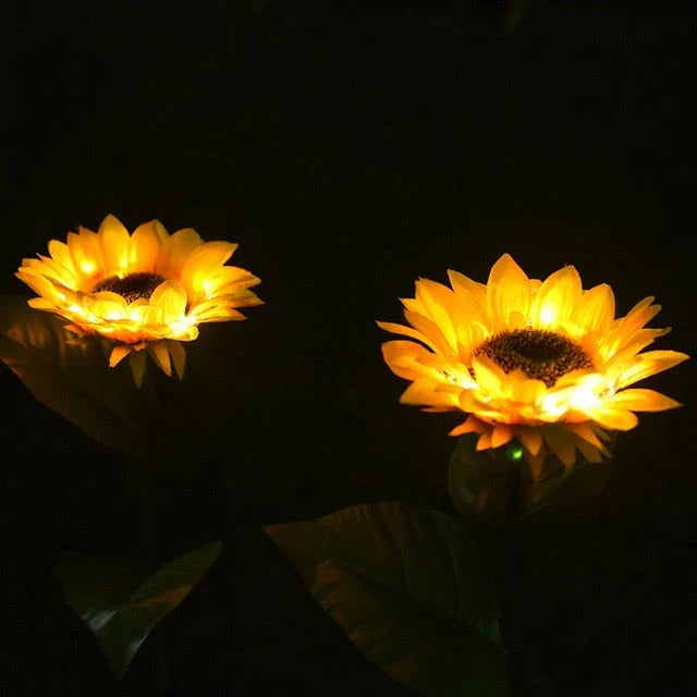 Elegant solar-powered sunflower lamps illuminating a serene outdoor garden pathway