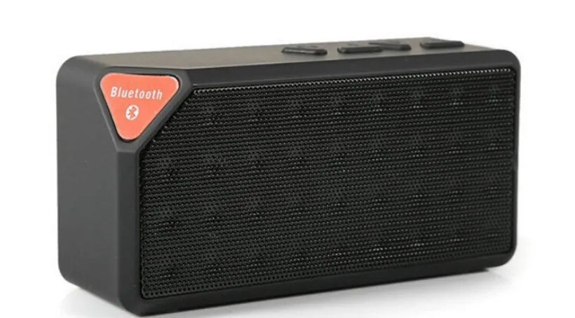 Cannon X3 small cube-shaped wireless Bluetooth speaker in multiple colours on a table.