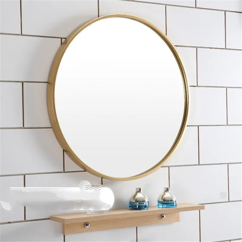 Round metal-framed wall mirror in black, white, or gold for bathroom.