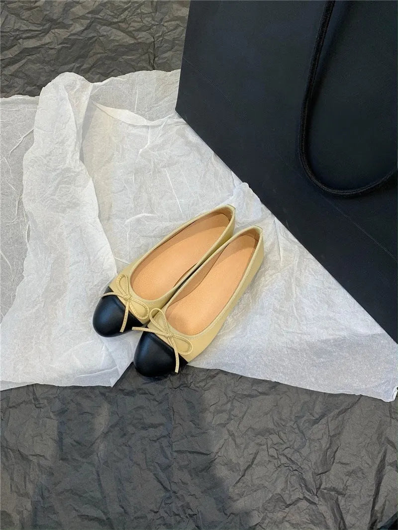 Apricot flat ballet shoes with a bowknot, round toe, and soft rubber sole.