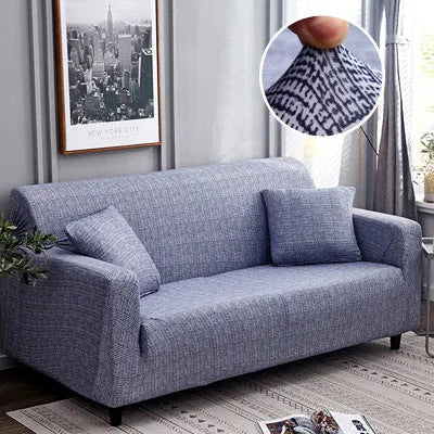 Printed stretchable sofa slipcover with geometric abstraction pattern on a three-seater sofa, showing tight fit and modern design.