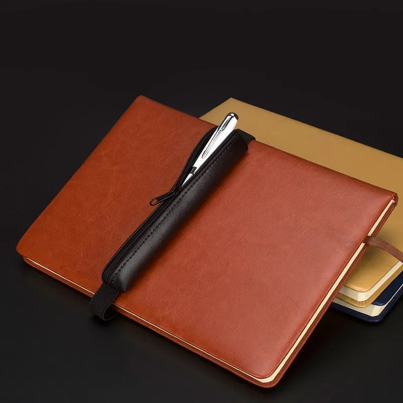 Long beige grey PU leather pencil case on a desk with pens