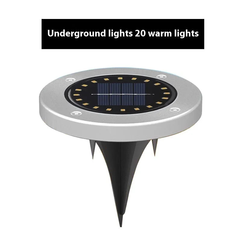 Stainless steel solar garden ground lamp installed in a lawn.