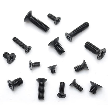 Black laptop machine screws with countersunk cross heads, shown in loose pile and close-up