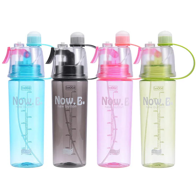 Green mist spray water bottle with clear volume scale and leakproof lid on a wooden table.