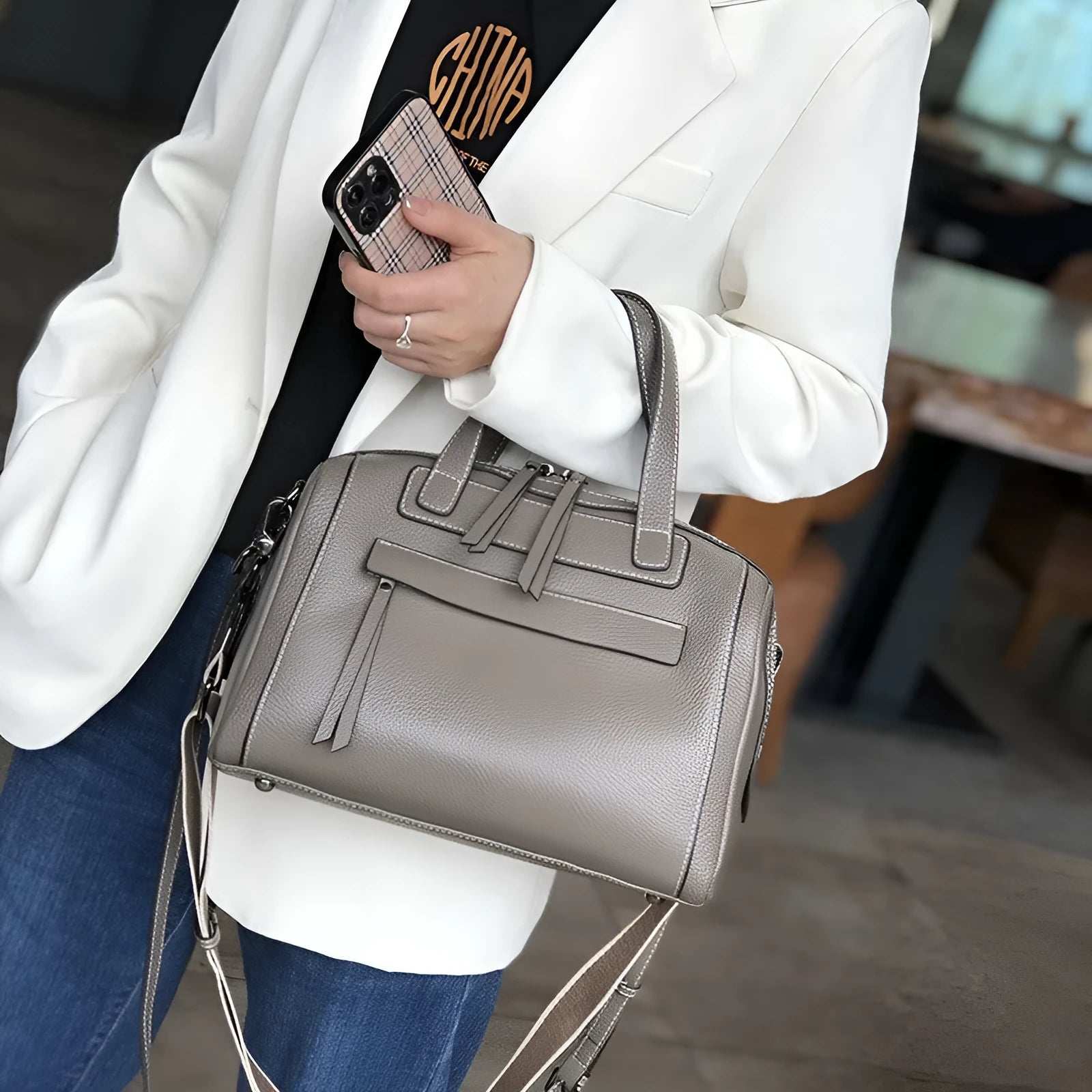 Genuine leather horizontal messenger bag in wine red with shoulder strap and internal zippered compartments.
