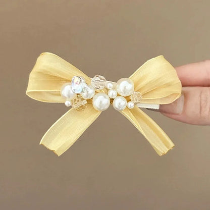 Yellow bow barrette hair clip with rhinestone pearls and duckbill clip mechanism