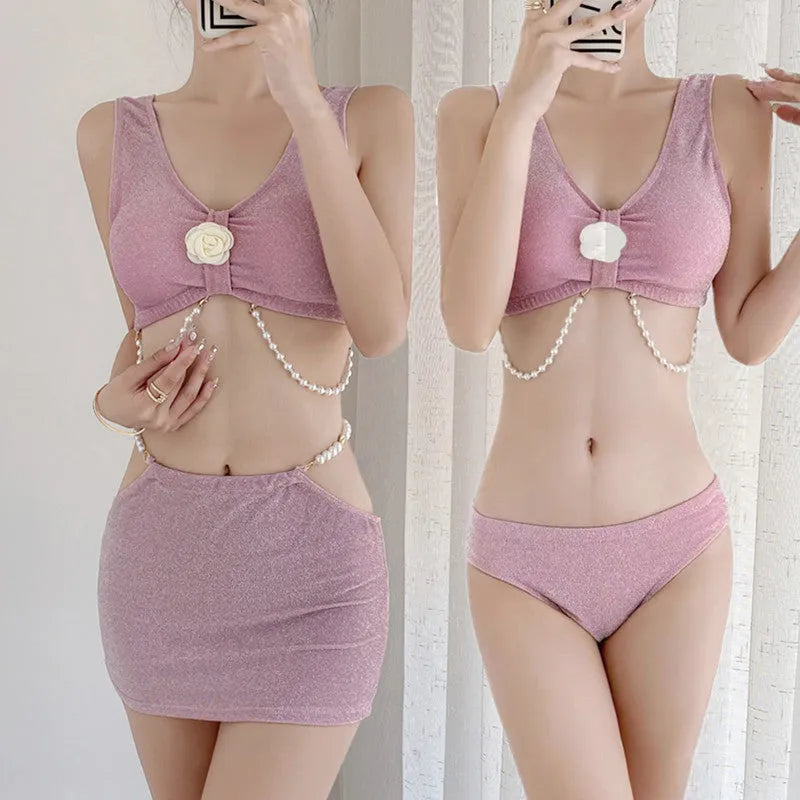 Pink and black polyester three-piece bikini swimsuit on a mannequin