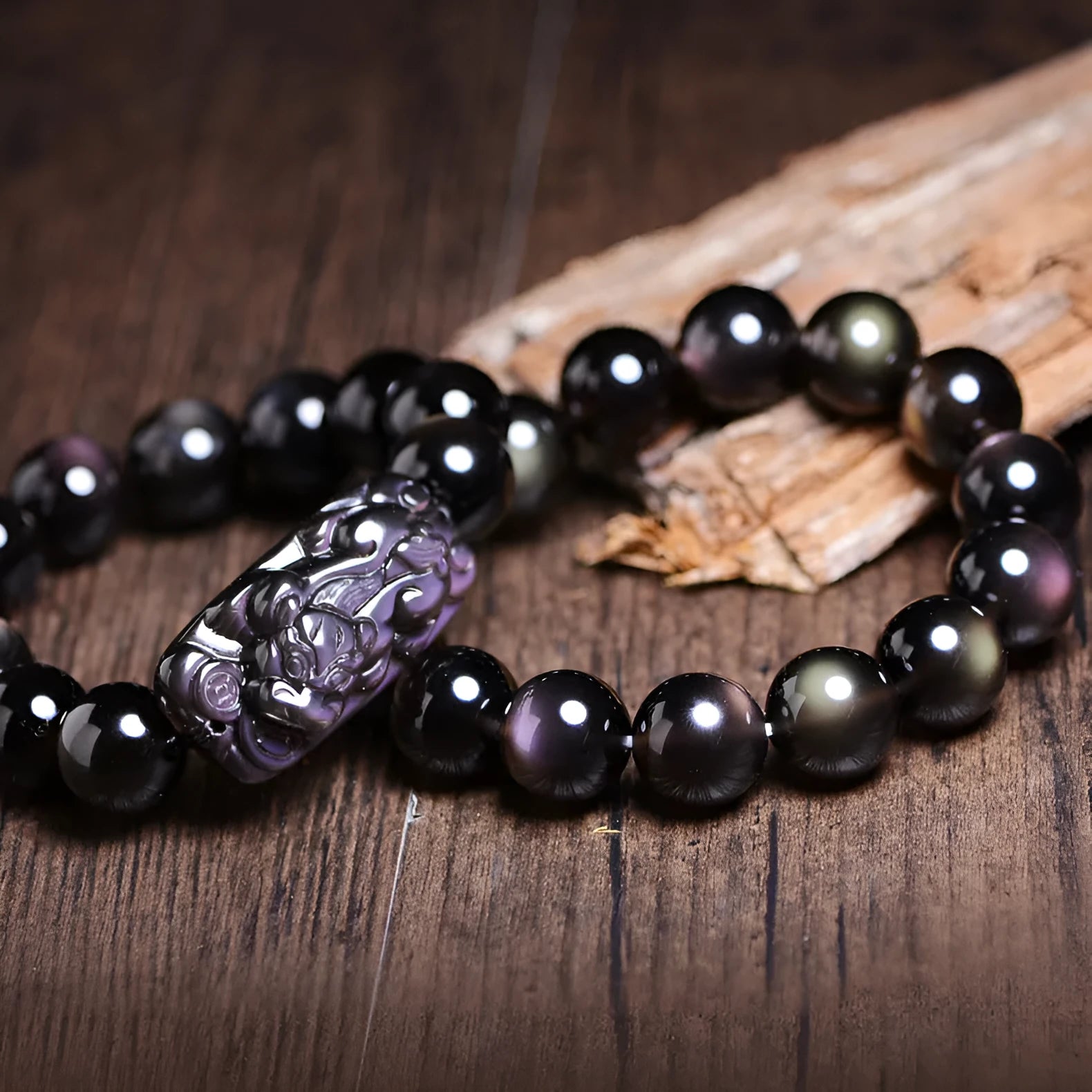 Natural crystal Pi Xiu bracelet with geometric beads on a wrist, showing ice stone colour.
