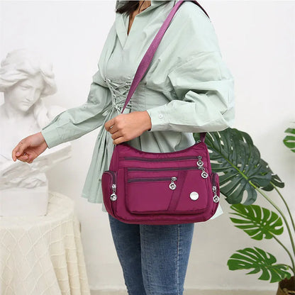 Women's nylon shoulder bag with multi-pocket design, zip opening and detachable handle in red, purple, black or army green
