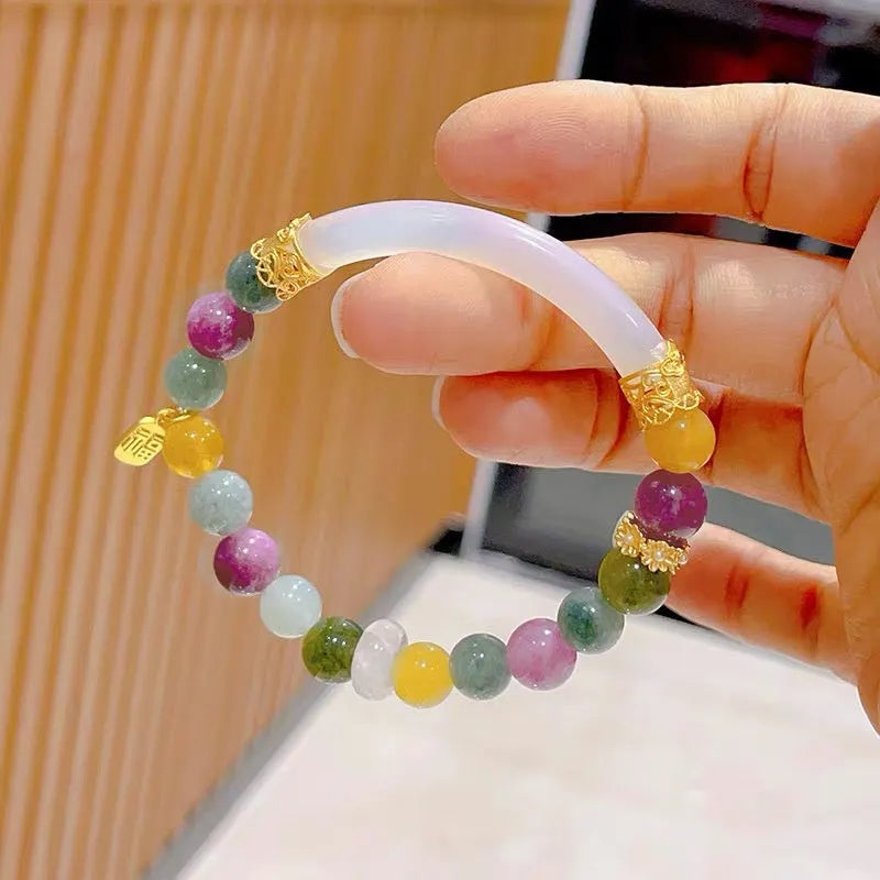 Rainbow-coloured tourmaline half bracelet for women on a wrist.