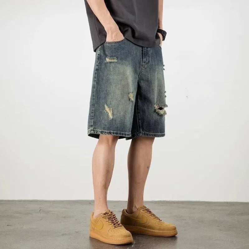 Men's blue loose fit denim shorts with distressed holes and straight leg