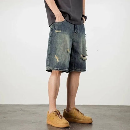 Men's blue loose fit denim shorts with distressed holes and straight leg