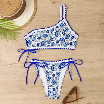 Blue one-shoulder bikini set with floral pattern on mannequin