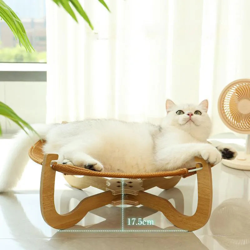 Brown woven rattan pet hammock bed for cats and small dogs on a flat surface.