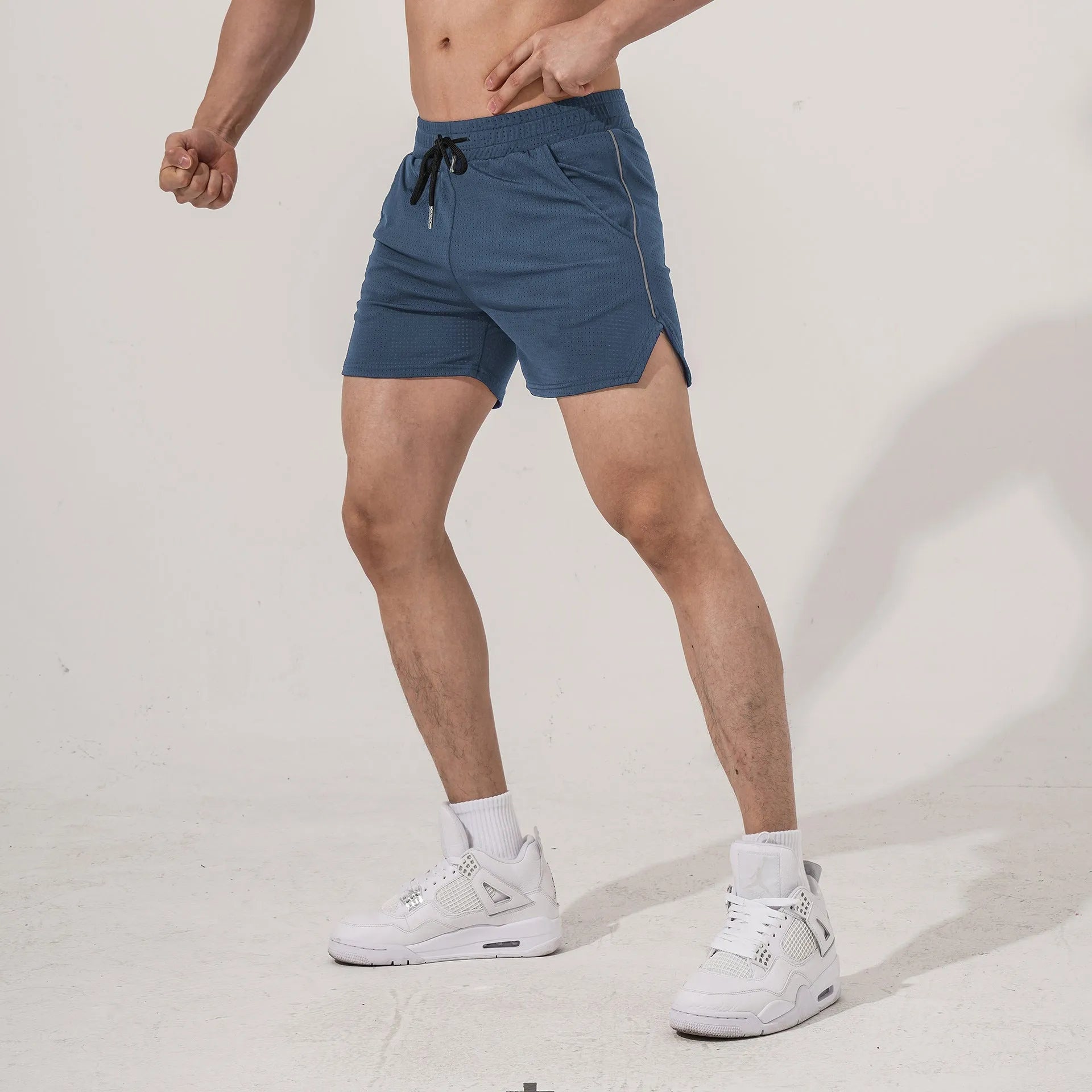Men's black polyester sports casual shorts with a straight-leg cut on a grey background.