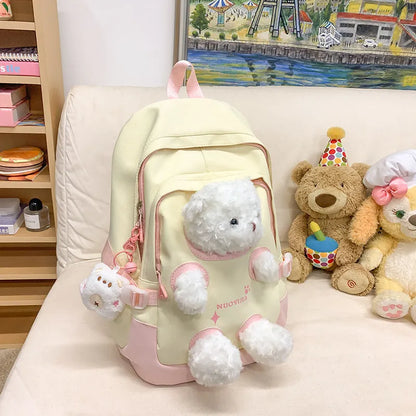 Macaron colour nylon school backpack with curved straps, shown in yellow pink, with a pendant attached.