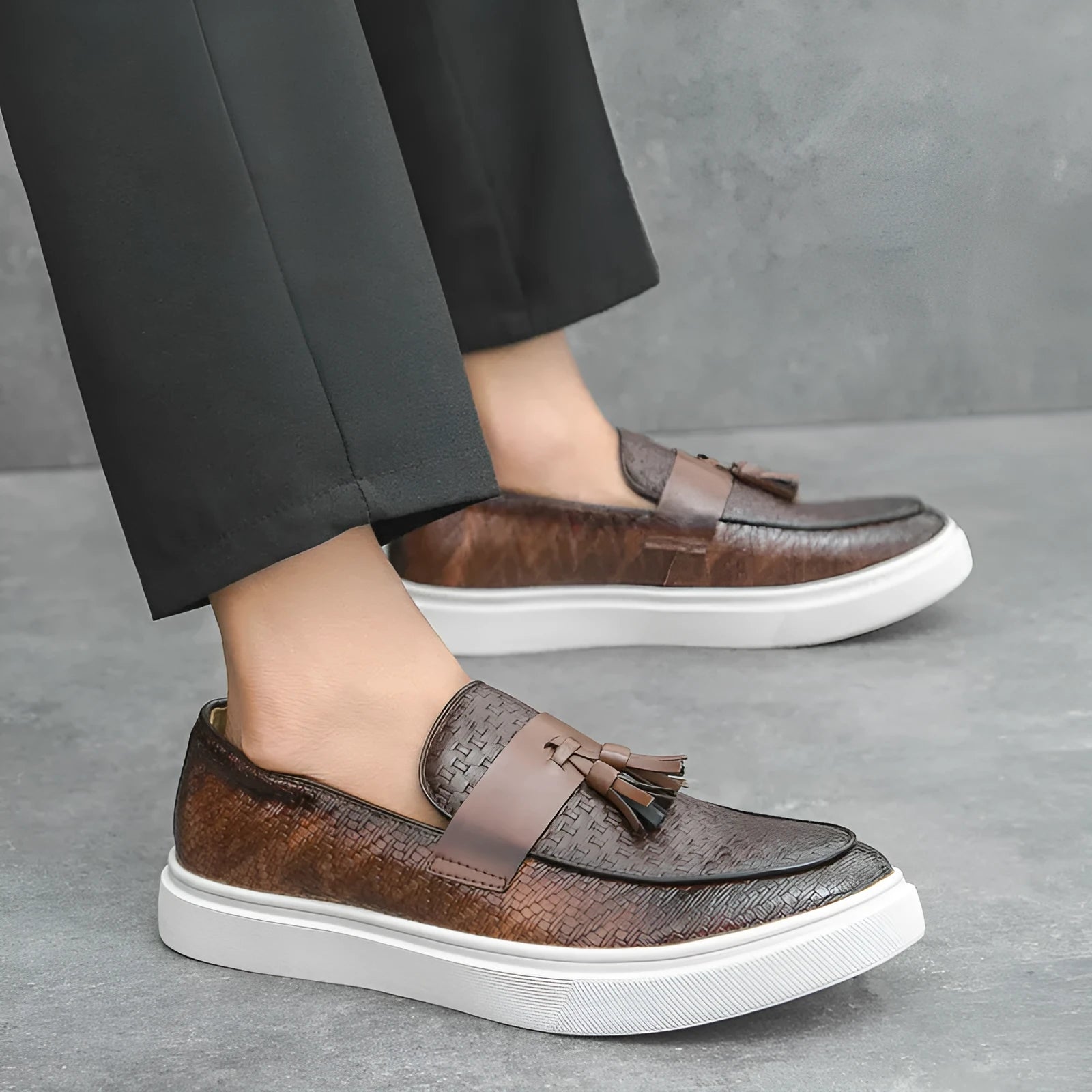 Men's black casual leather shoes with fringe detailing on round toe and low heel