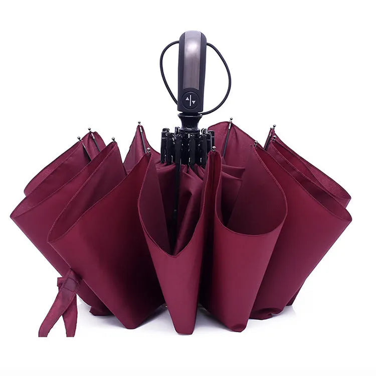 Triple-folding automatic sun-shade umbrella in black with steel ribs and rubber handle, showing compact folded size.