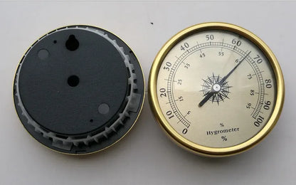 Analogue thermometer and hygrometer with aluminium outer ring and dial showing temperature and humidity scales
