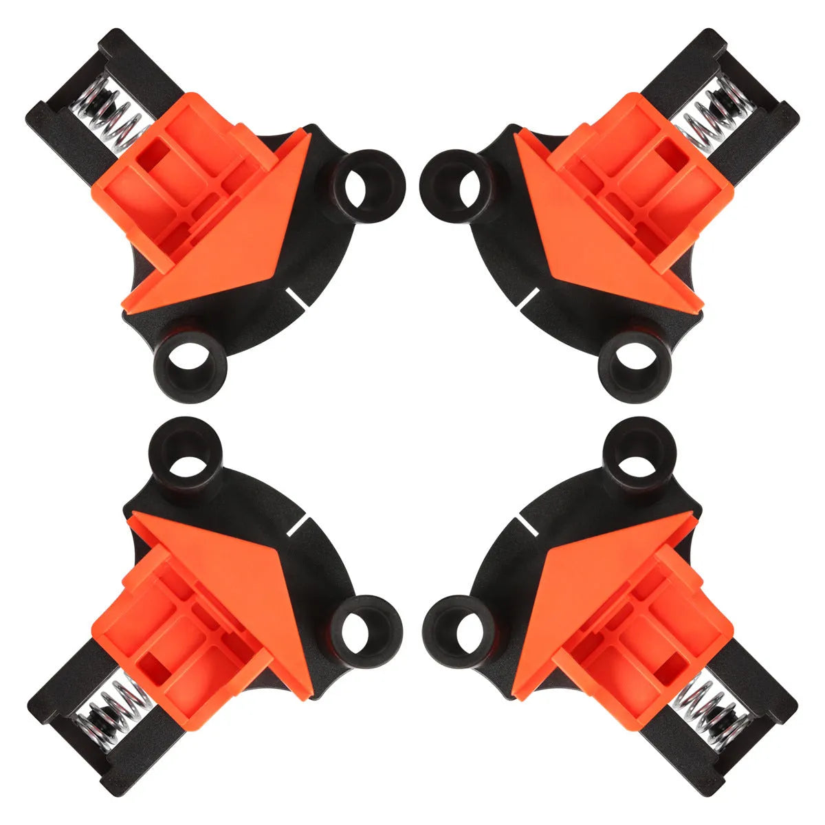 Four white plastic right angle clamps for woodworking and picture frame assembly on a workbench.