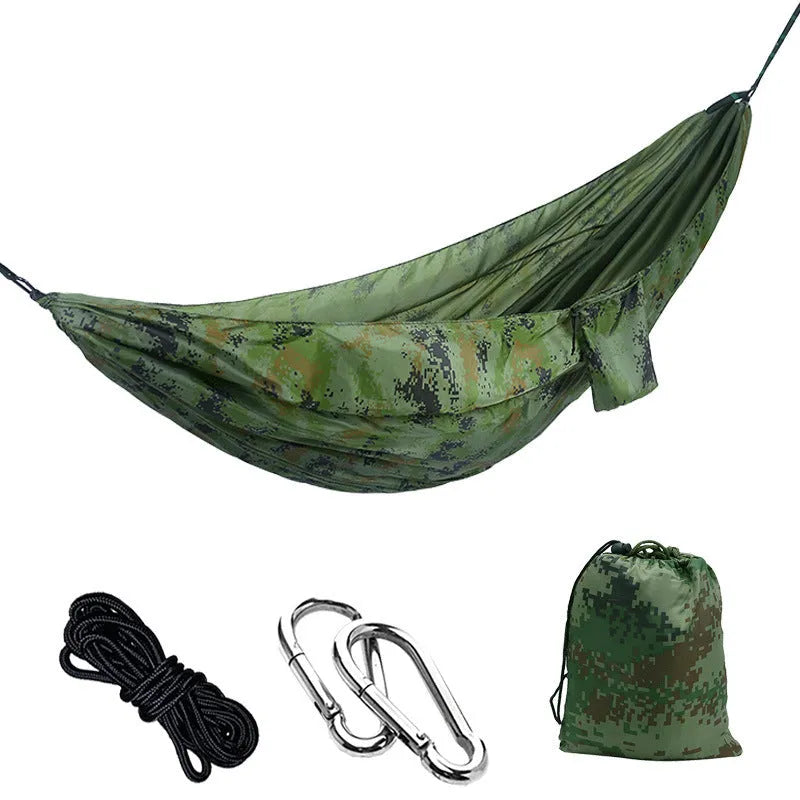 Parachute cloth double camping hammock in chosen colour, with black buckles and round ropes on a tree.