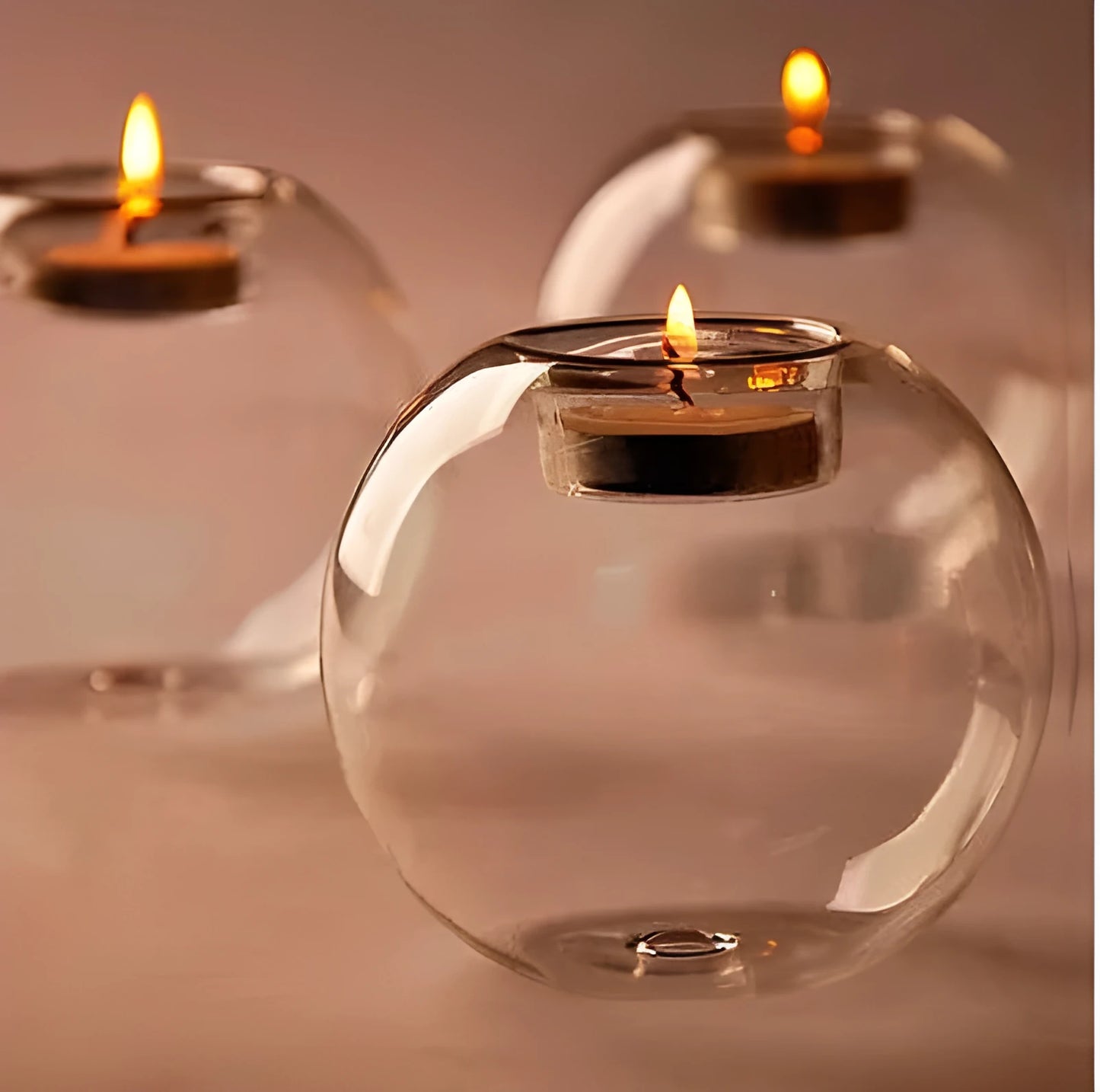 Handmade hollow round glass candle holder in European style on a table.